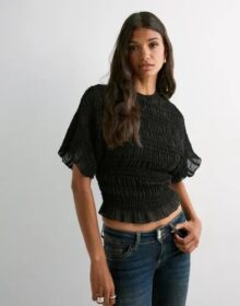 Nelly Musta – Frill Turtleneck Blouse