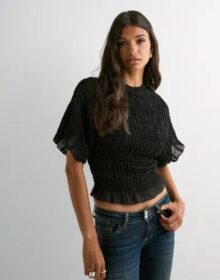 Nelly Musta – Frill Turtleneck Blouse